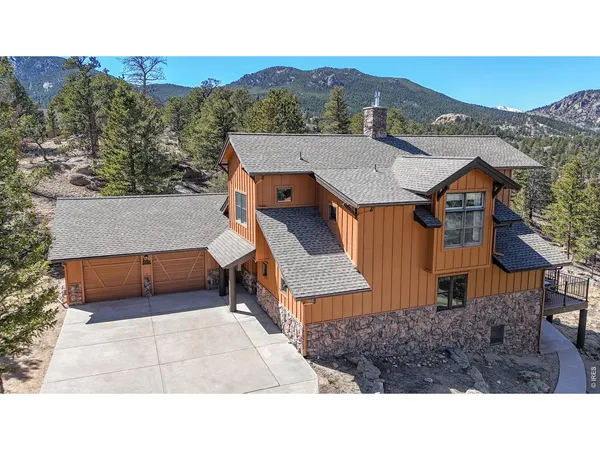 a aerial view of a house with a yard