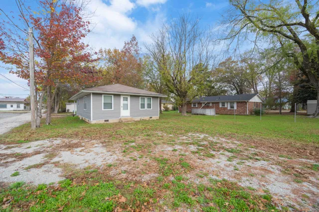 a view of house with yard
