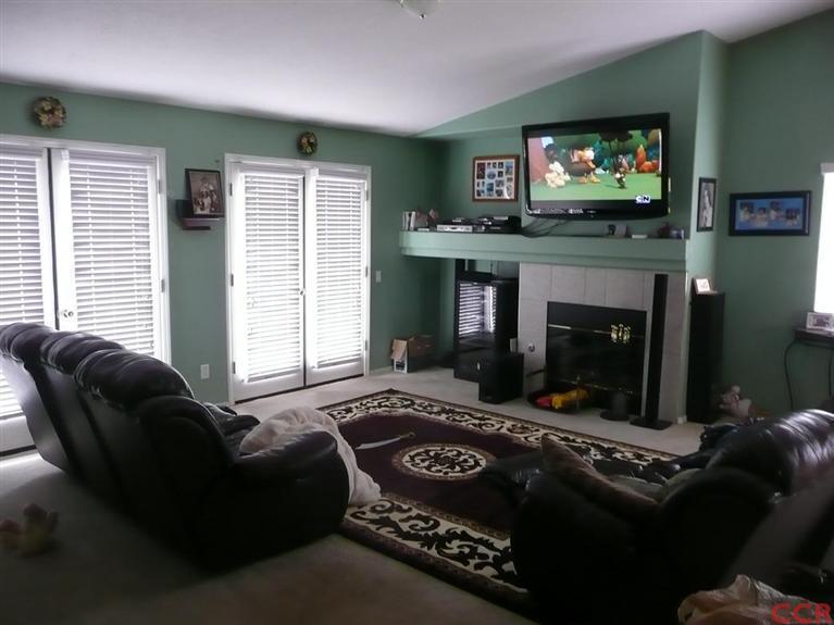 2451 Bicknell Avenue Santa Maria, CA 93458 - Photo 4 of 10 a living room with furniture a flat screen tv and a fireplace