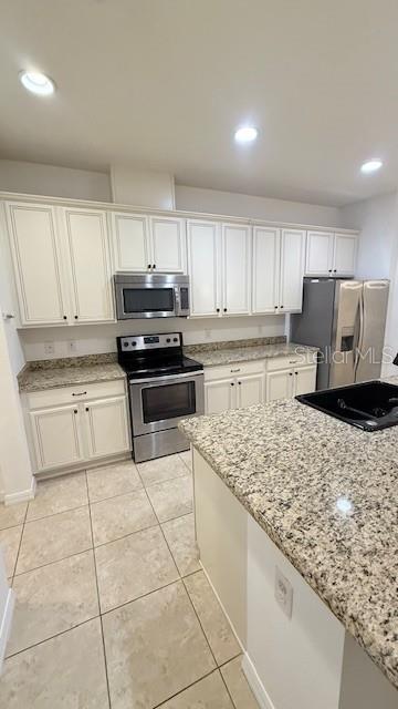 13718 Beckman Drive Windermere, FL 34786 - Photo 11 of 20 a kitchen with a stove a sink and a refrigerator