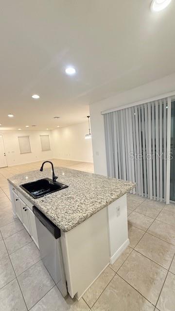 13718 Beckman Drive Windermere, FL 34786 - Photo 13 of 20 a kitchen with granite countertop a sink and white cabinets