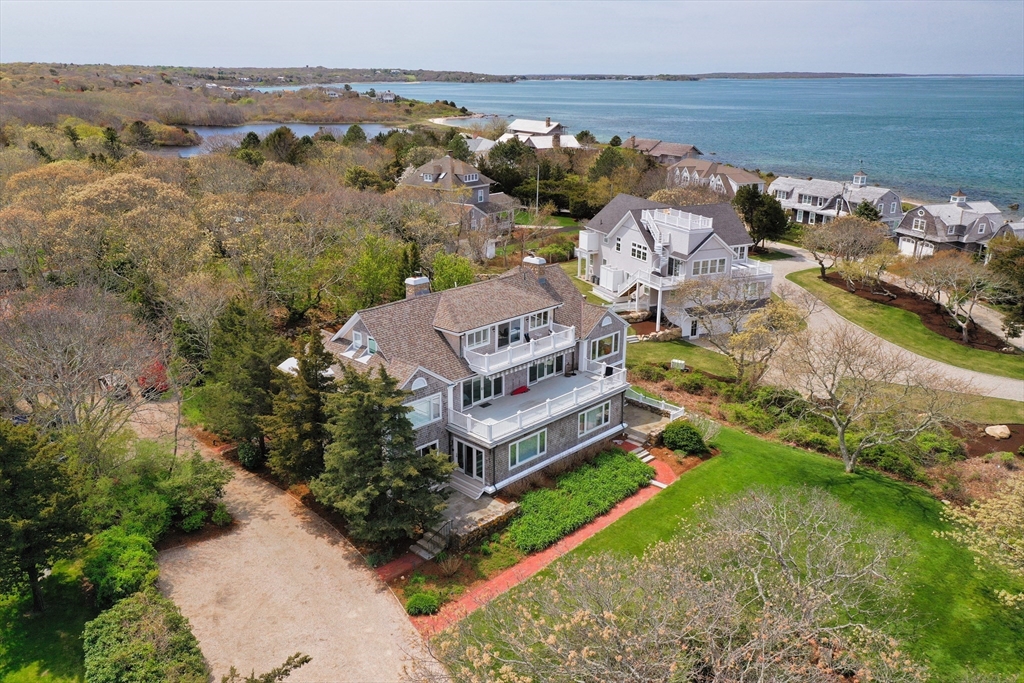 an aerial view of a house with a garden and lake view
