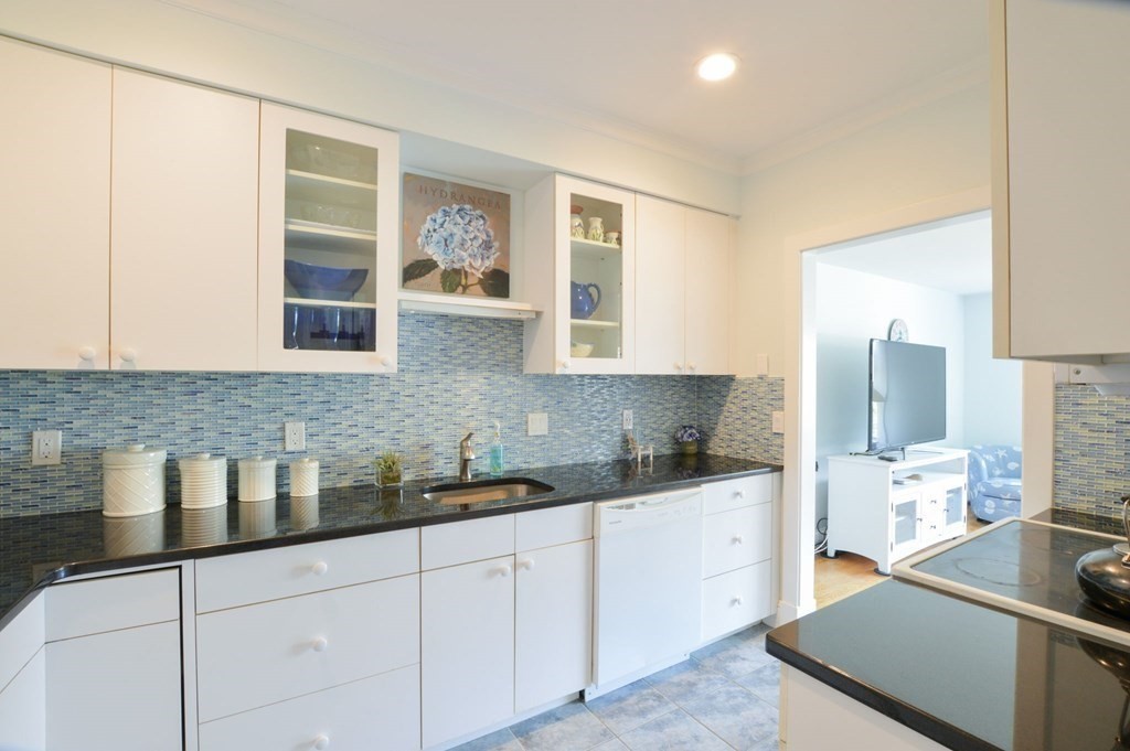 46 Gunning Point Road, Unit 2 Falmouth, MA 02540 - Photo 11 of 29 a kitchen with stainless steel appliances granite countertop a sink stove and cabinets