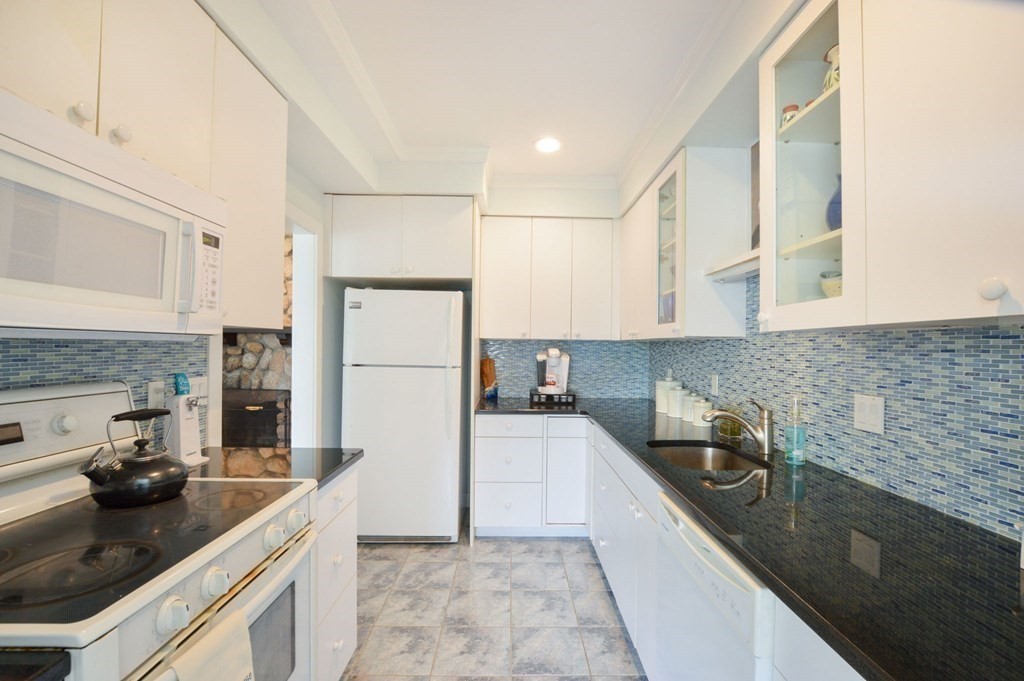46 Gunning Point Road, Unit 2 Falmouth, MA 02540 - Photo 12 of 29 a kitchen with a sink and refrigerator