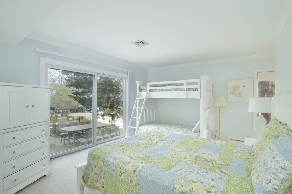 46 Gunning Point Road, Unit 2 Falmouth, MA 02540 - Photo 13 of 29 a bedroom with a bed and a large window