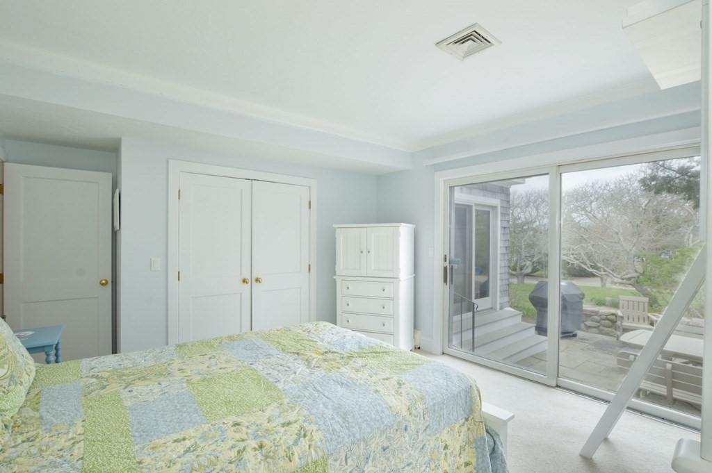 46 Gunning Point Road, Unit 2 Falmouth, MA 02540 - Photo 14 of 29 a bedroom with a bed and glass door