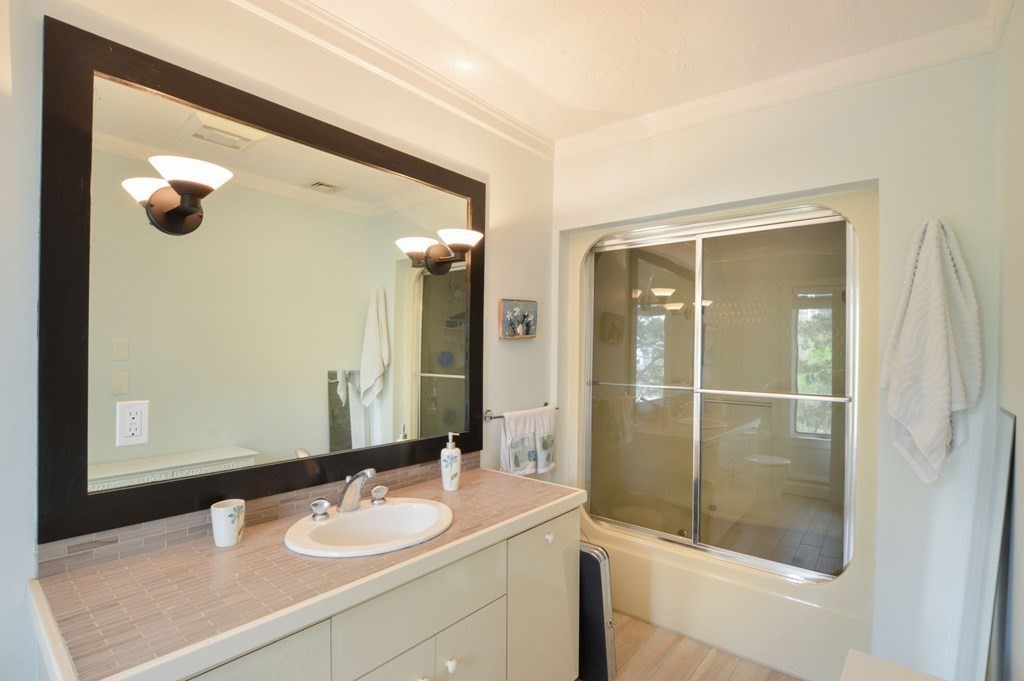 46 Gunning Point Road, Unit 2 Falmouth, MA 02540 - Photo 15 of 29 a bathroom with a sink and mirror with shower