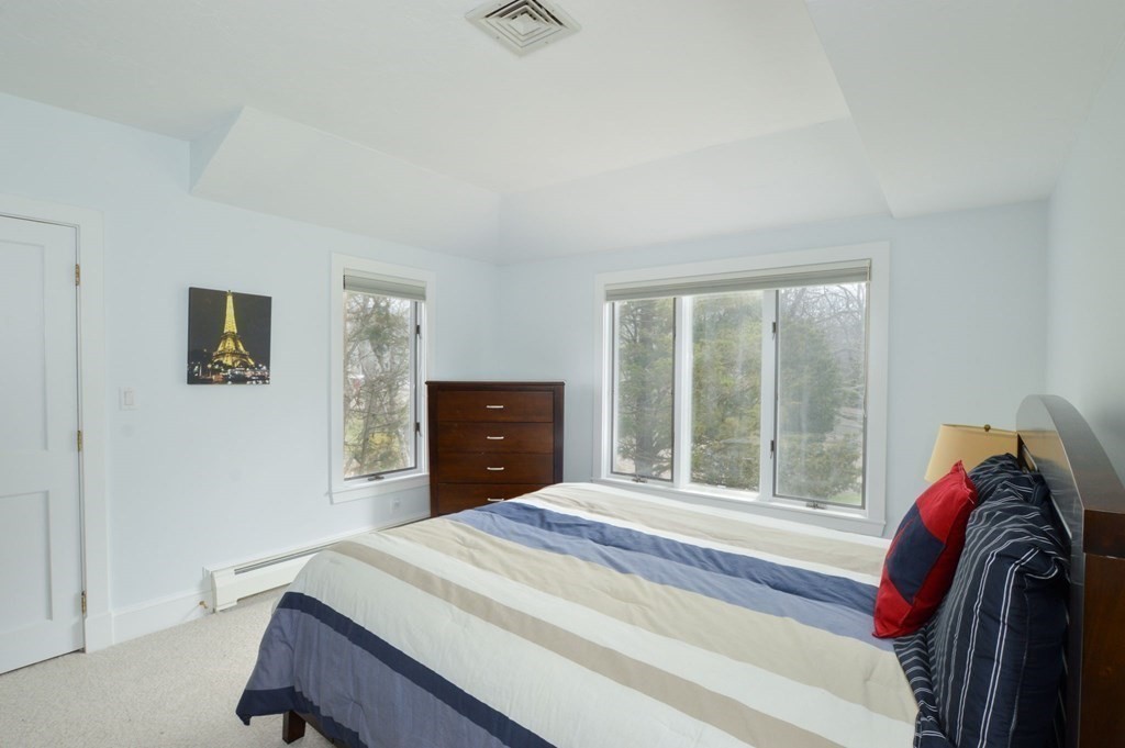 46 Gunning Point Road, Unit 2 Falmouth, MA 02540 - Photo 16 of 29 a bedroom with a bed and a large window