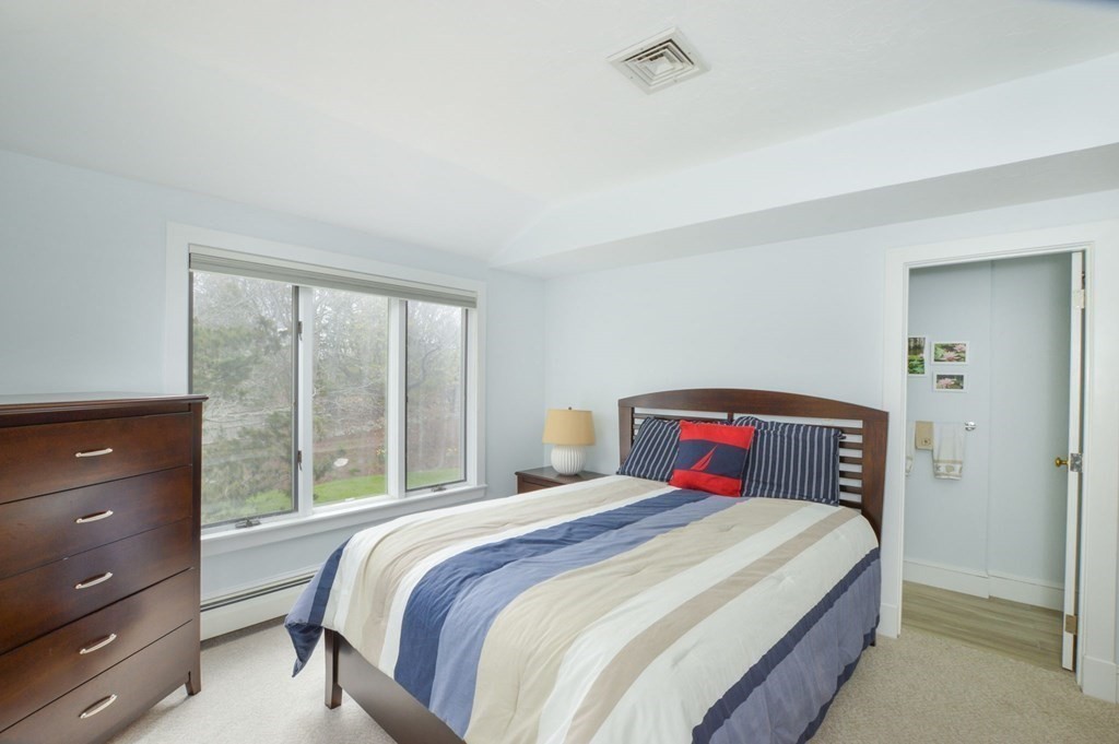 46 Gunning Point Road, Unit 2 Falmouth, MA 02540 - Photo 17 of 29 a bedroom with a large bed and a window