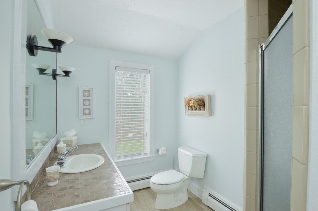 46 Gunning Point Road, Unit 2 Falmouth, MA 02540 - Photo 18 of 29 a bathroom with a granite countertop sink and a mirror