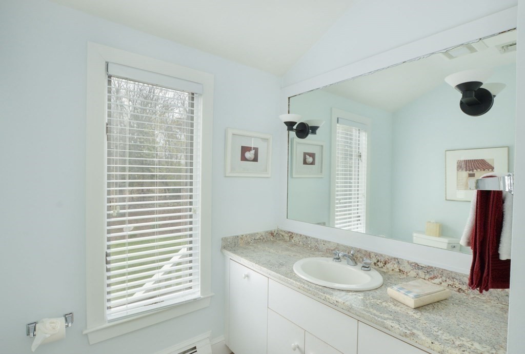 46 Gunning Point Road, Unit 2 Falmouth, MA 02540 - Photo 19 of 29 a bathroom with a granite countertop sink and a mirror