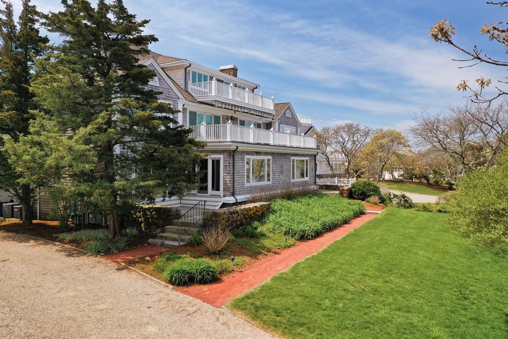 46 Gunning Point Road, Unit 2 Falmouth, MA 02540 - Photo 2 of 29 a front view of a house with garden