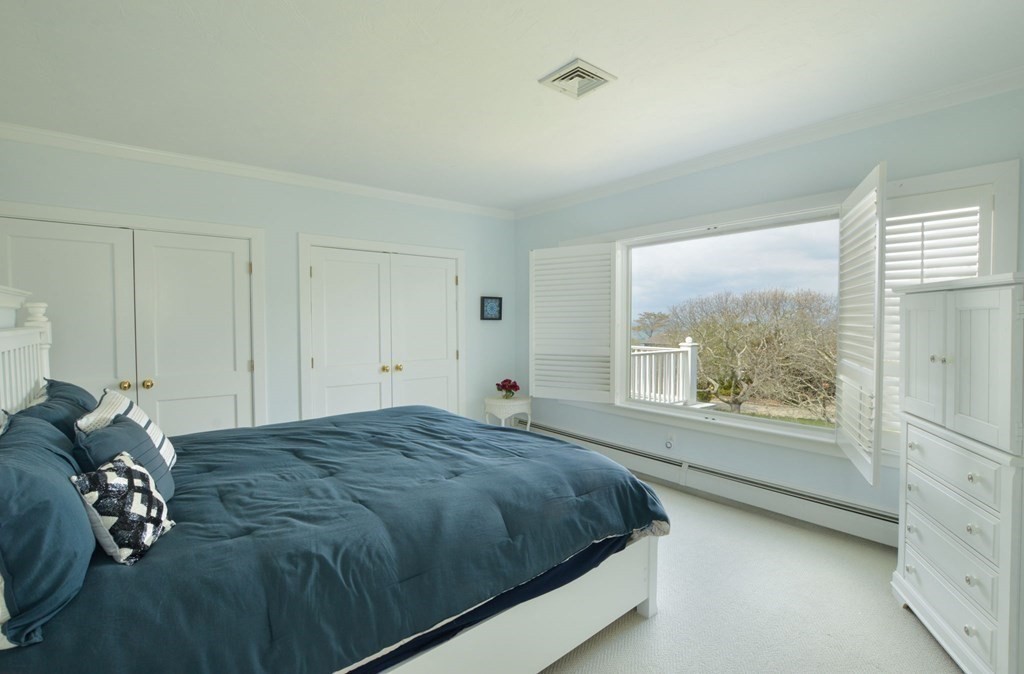 46 Gunning Point Road, Unit 2 Falmouth, MA 02540 - Photo 21 of 29 a bedroom with a bed and window