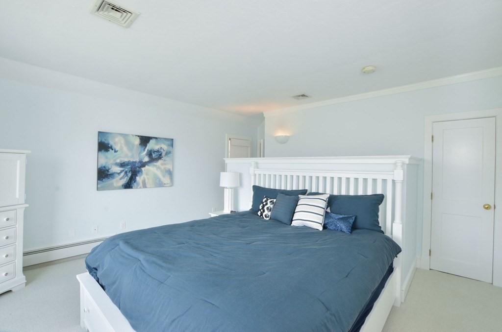 46 Gunning Point Road, Unit 2 Falmouth, MA 02540 - Photo 22 of 29 a bedroom with a bed and a window