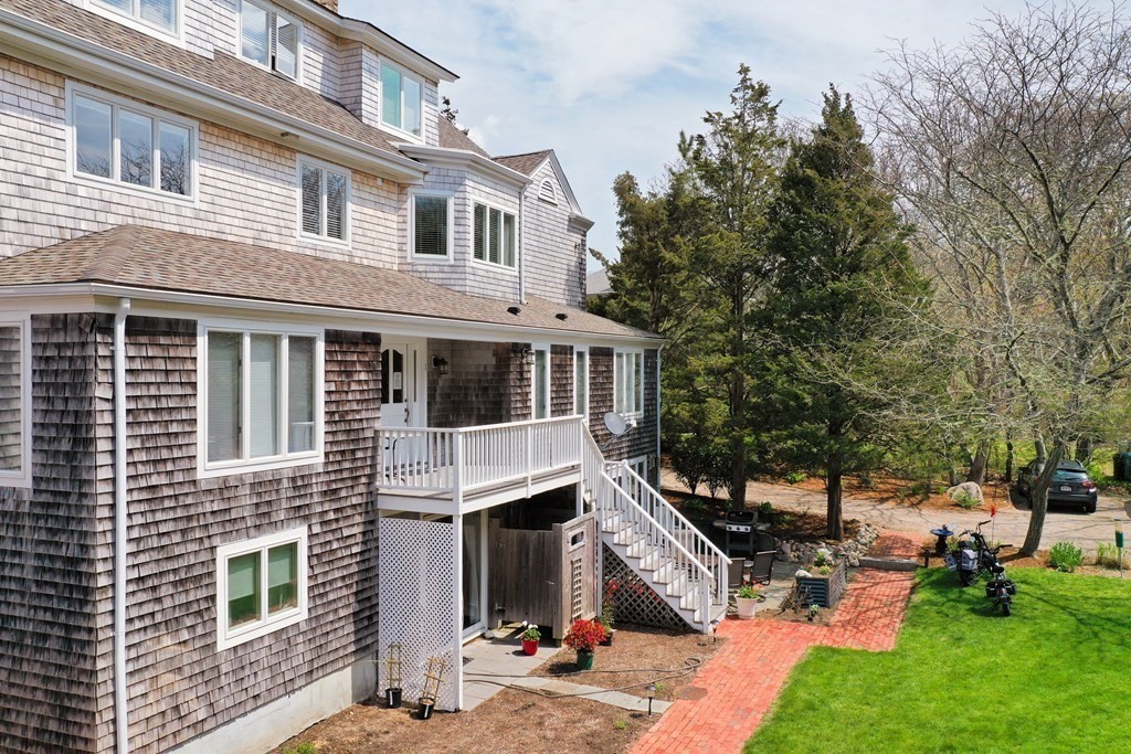 46 Gunning Point Road, Unit 2 Falmouth, MA 02540 - Photo 3 of 29 a view of a house with a yard and sitting area