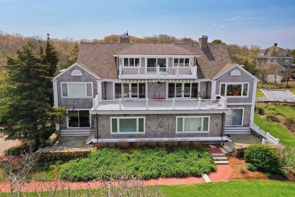 46 Gunning Point Road, Unit 2 Falmouth, MA 02540 - Photo 4 of 29 a front view of a house with a yard