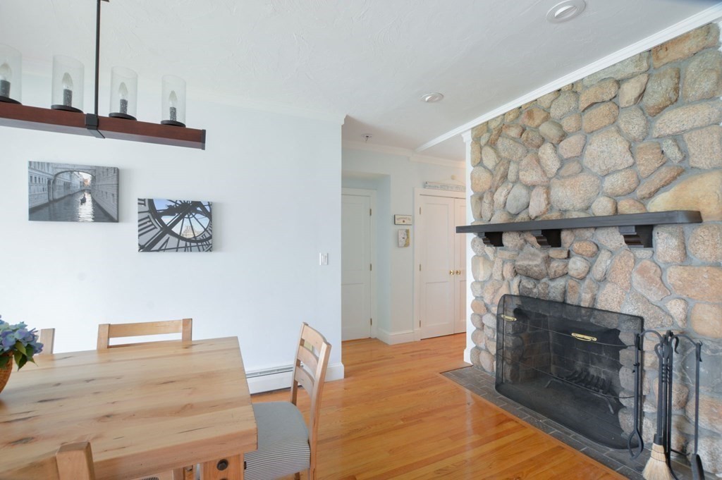 46 Gunning Point Road, Unit 2 Falmouth, MA 02540 - Photo 6 of 29 a living room with furniture and a fireplace