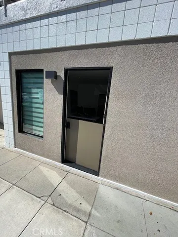 a living room with furniture a flat screen tv and kitchen view