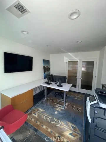 a work room with furniture and a flat screen tv