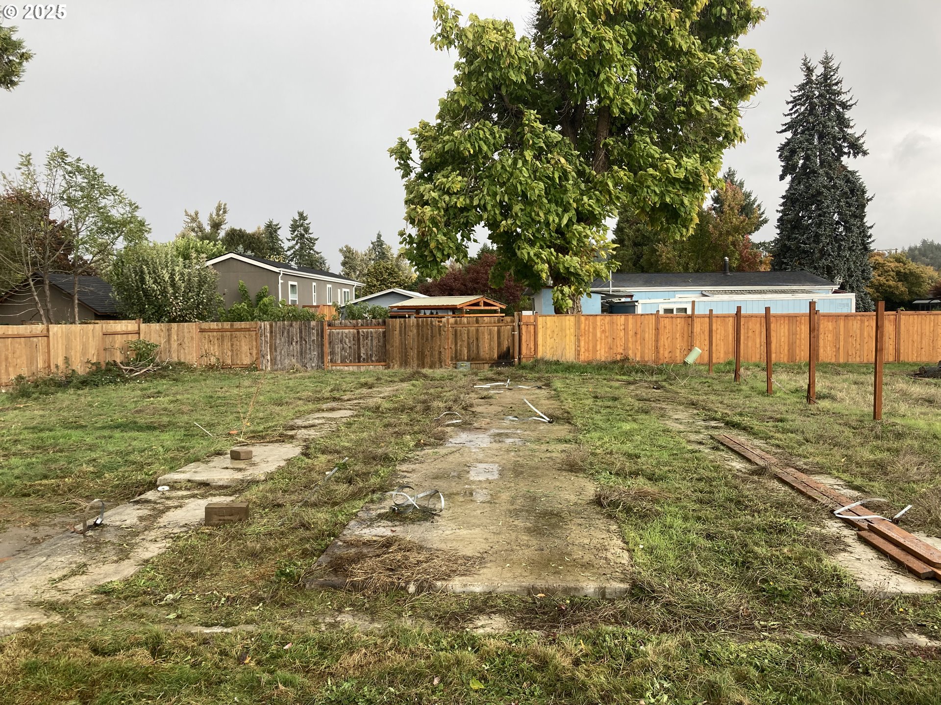65 Kremont Avenue Springfield, OR 97477 - Photo 2 of 5 a backyard of a house with lots of green space and lake view