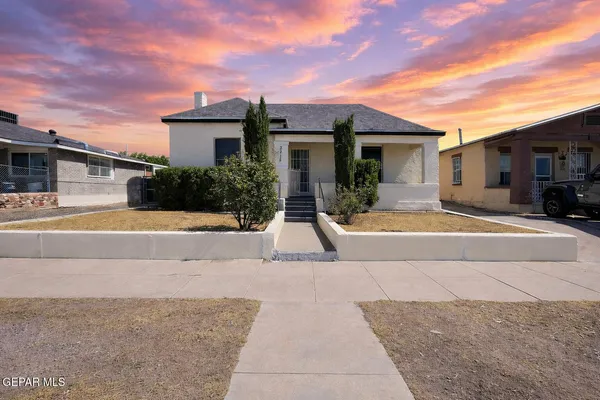 a view of a house with outdoor space and sitting area