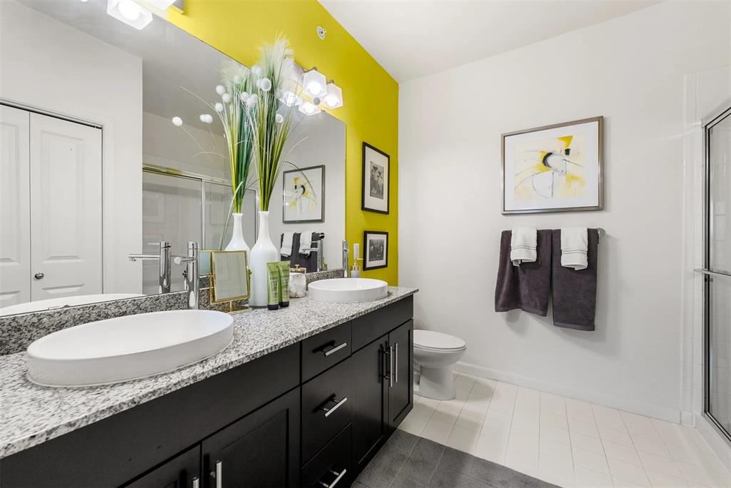 12700 Ridgeline Boulevard, Unit 31111207 Cedar Park, TX 78613 - Photo 4 of 16 a bathroom with a granite countertop sink a mirror and a toilet