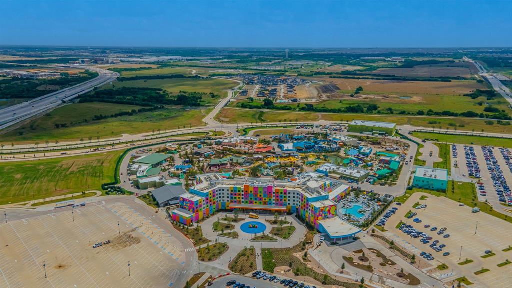 2521 Maidenhair Road Frisco, TX 75033 - Photo 36 of 39 Expansive aerial perspective showcasing a vibrant resort complex featuring multiple buildings, extensive water park amenities, and a prominent central hotel structure