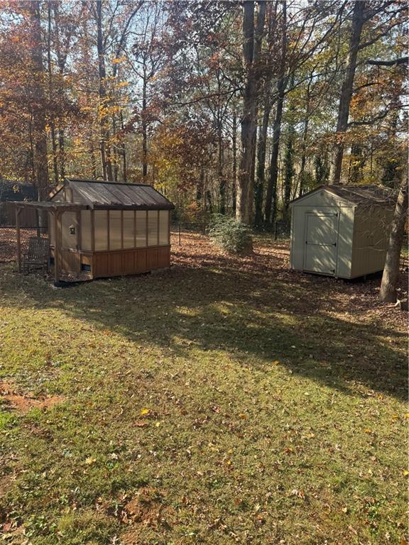 1455 Timberlane Road Snellville, GA 30078 - Photo 25 of 25 a view of a backyard with large trees and wooden fence
