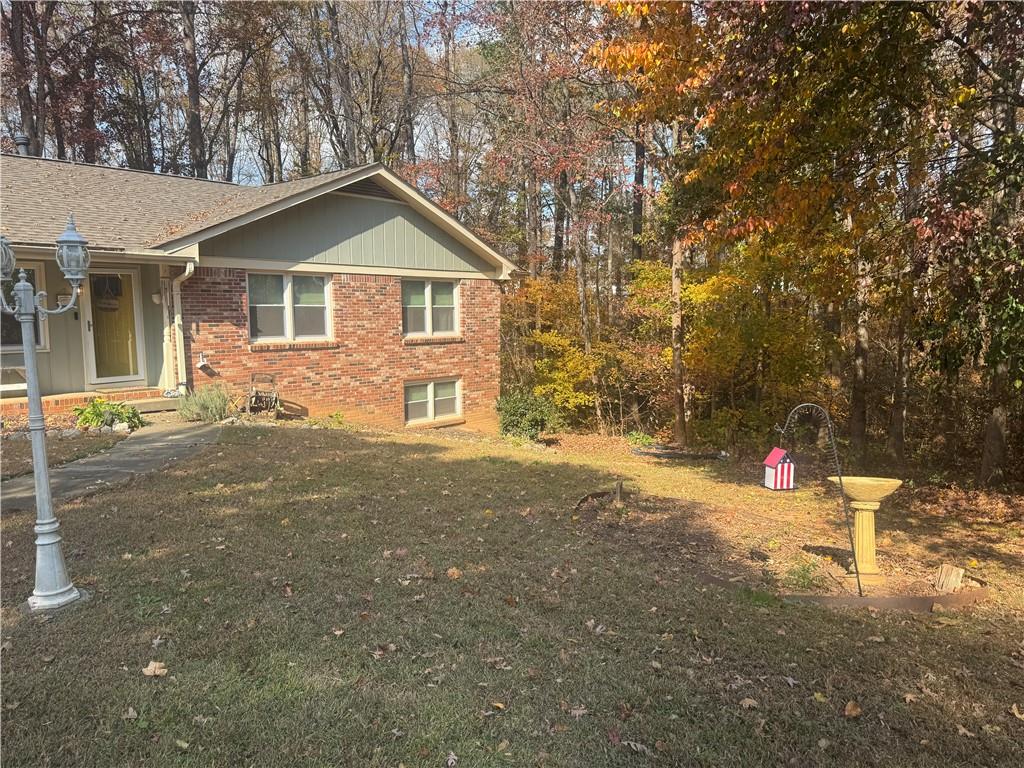 1455 Timberlane Road Snellville, GA 30078 - Photo 3 of 25 a view of a house with a yard