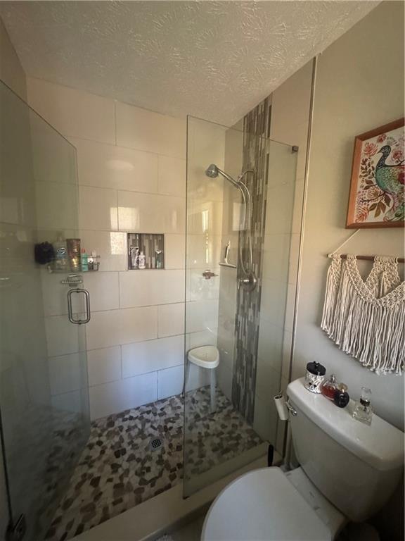 1455 Timberlane Road Snellville, GA 30078 - Photo 7 of 25 a bathroom with a sink toilet and shower