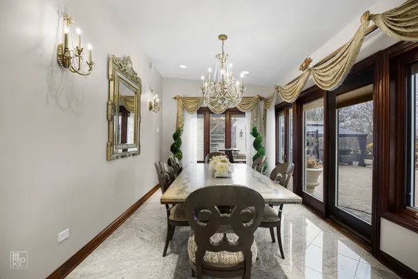 a view of a dining room with furniture a chandelier and wooden floor