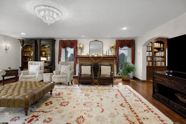 a living room with furniture a fireplace and a flat screen tv