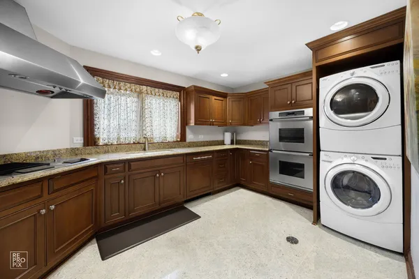 a kitchen with a stove top oven sink and cabinets