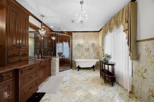 a bathroom with a tub sink and mirror