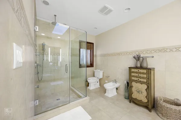 a bathroom with a shower toilet and sink