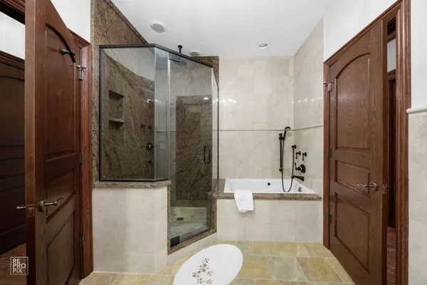 a bathroom with a bathtub and a shower