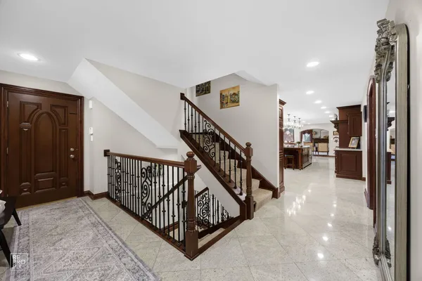 a view of a hallway with a livingroom with furniture and stairs