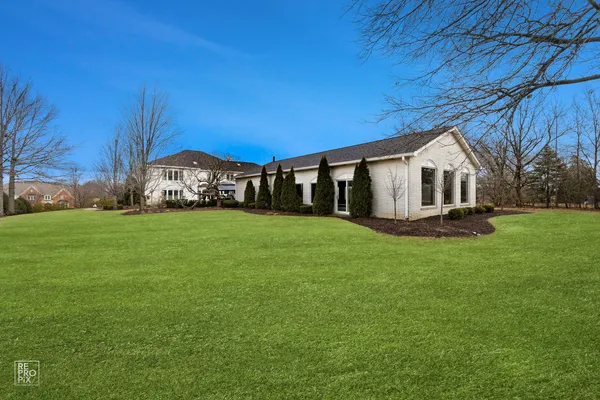 a view of a house with backyard porch and sitting area