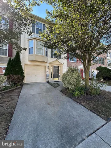 a white house that has a tree in front of it