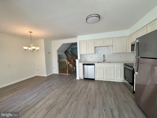 a kitchen with stainless steel appliances a refrigerator sink and cabinets