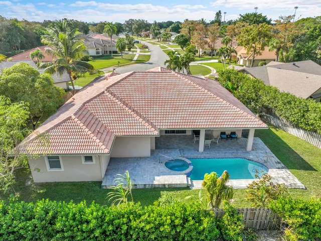 an aerial view of a house with swimming pool garden and patio