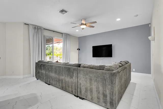 a view of a dining room with furniture and a chandelier