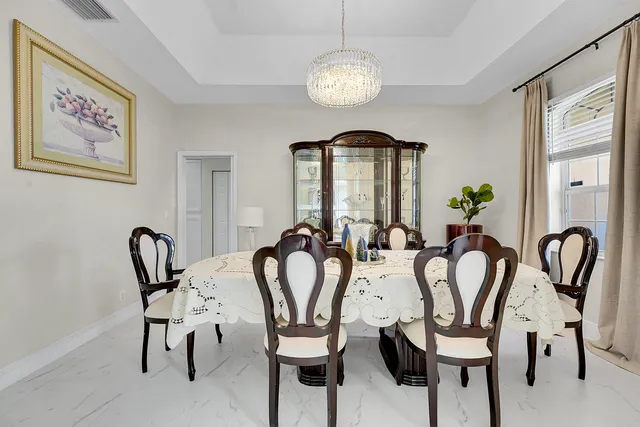 a view of a dining room with furniture and chandelier