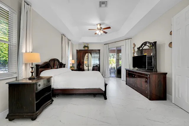 a bedroom with a bed lamp and a chandelier