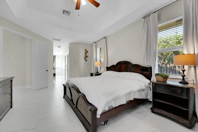 a spacious bathroom with double vanity a window a bathtub and a shower