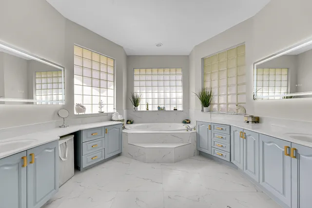 a bathroom with a tub sink and mirror