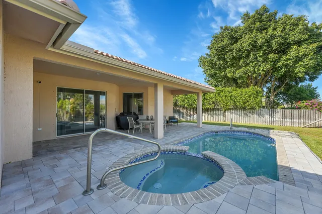 a dining room with furniture and a floor to ceiling window