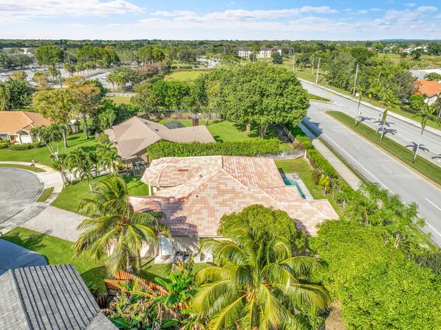 an aerial view of a house with a yard and potted plants