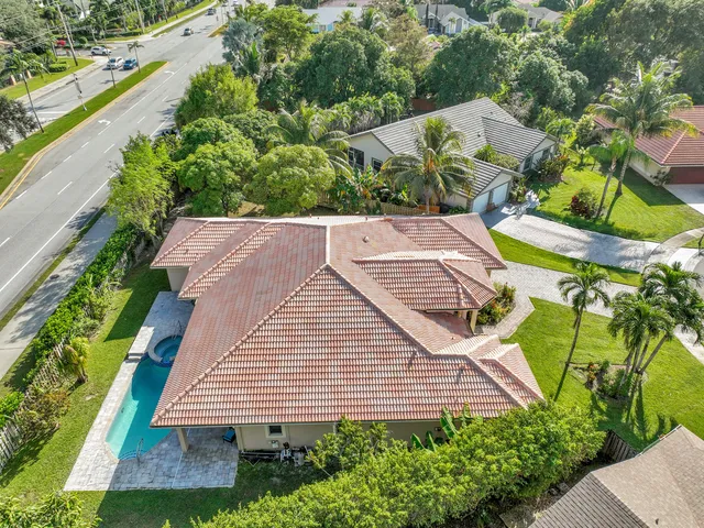 an aerial view of residential houses with outdoor space and street view