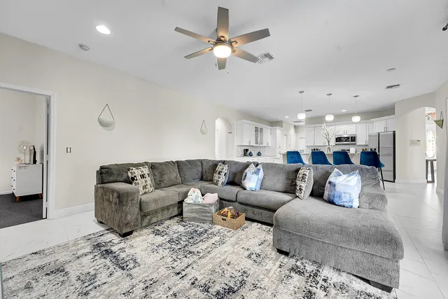 a kitchen with white cabinets and appliances